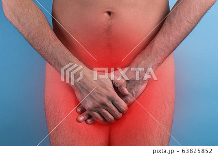 Man in underwear standing isolated on grey background covering his