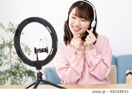 女性 スマートフォン 自撮り ポーズの写真素材