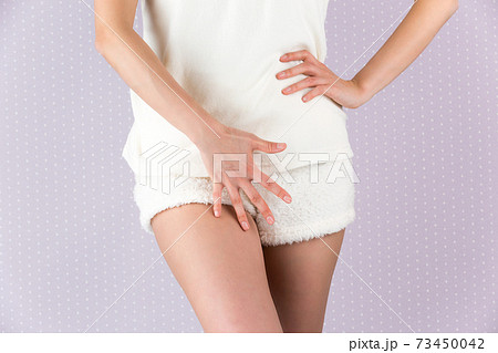 Woman In Panties Holding Her Crotch On A White Background Stock