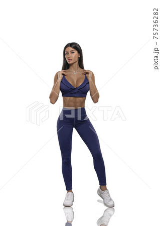 girl in black leggings and a top stay back on a white background