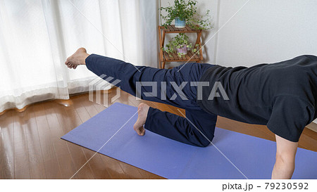 Funny Yoga Exercise at Home. Man Doing Dog Pose with Many Cats