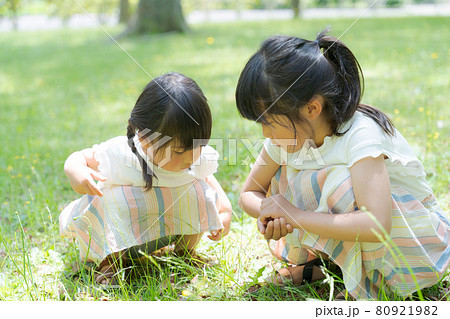 しゃがむ 子供 女の子の写真素材