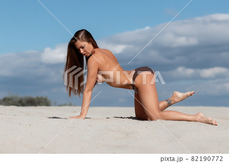 Naked women in panties hugging on beach - Stock Photo [81729889