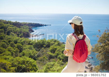 Sporty Woman Hiker with Backpack and Trekking Sticks Hiking in the