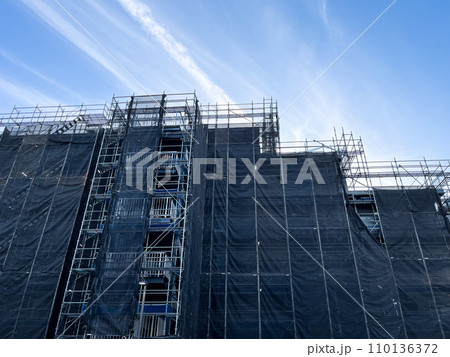 足場の組まれた外壁補修中のマンション